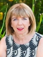 Headshot of Professor Ann McGrath outside infront of plants