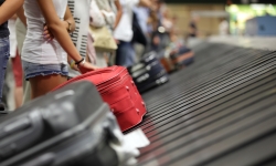 visitors waiting for luggage at Changi Airport