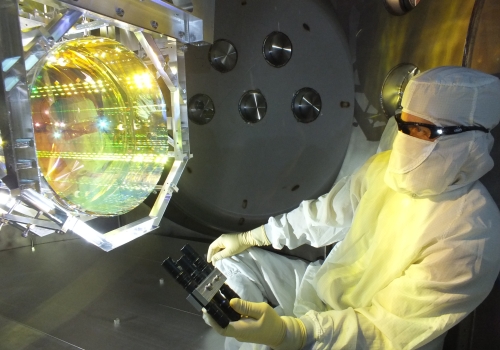 Image: Inspecting LIGO’s optics for contaminants prior to  sealing up the chamber and pumping the vacuum system  down, by illuminating its surface with light at a glancing angle. Image courtesy: Matt Heintze/Caltech/MIT/LIGO Lab.