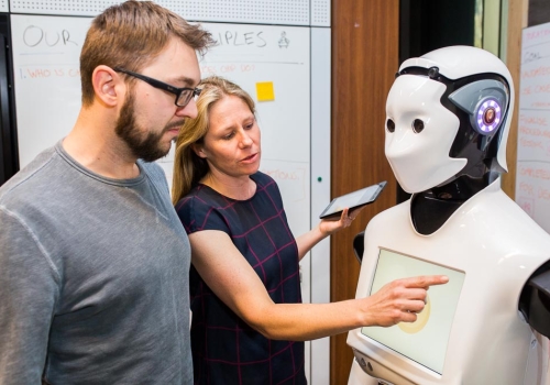 Magic Lab PhD students working in the CBA Innovation Lab on Human-Robot Interaction Experiments with CBA Customers.