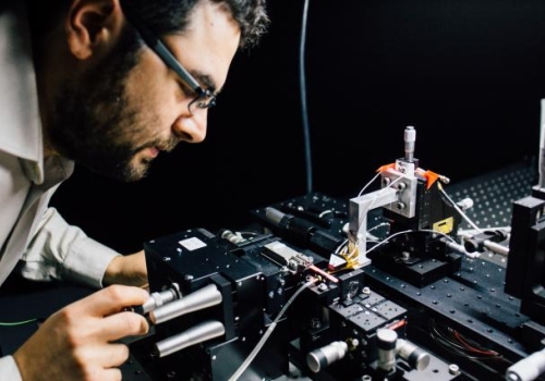 associate Professor Mirko Lobino works on the microchip.